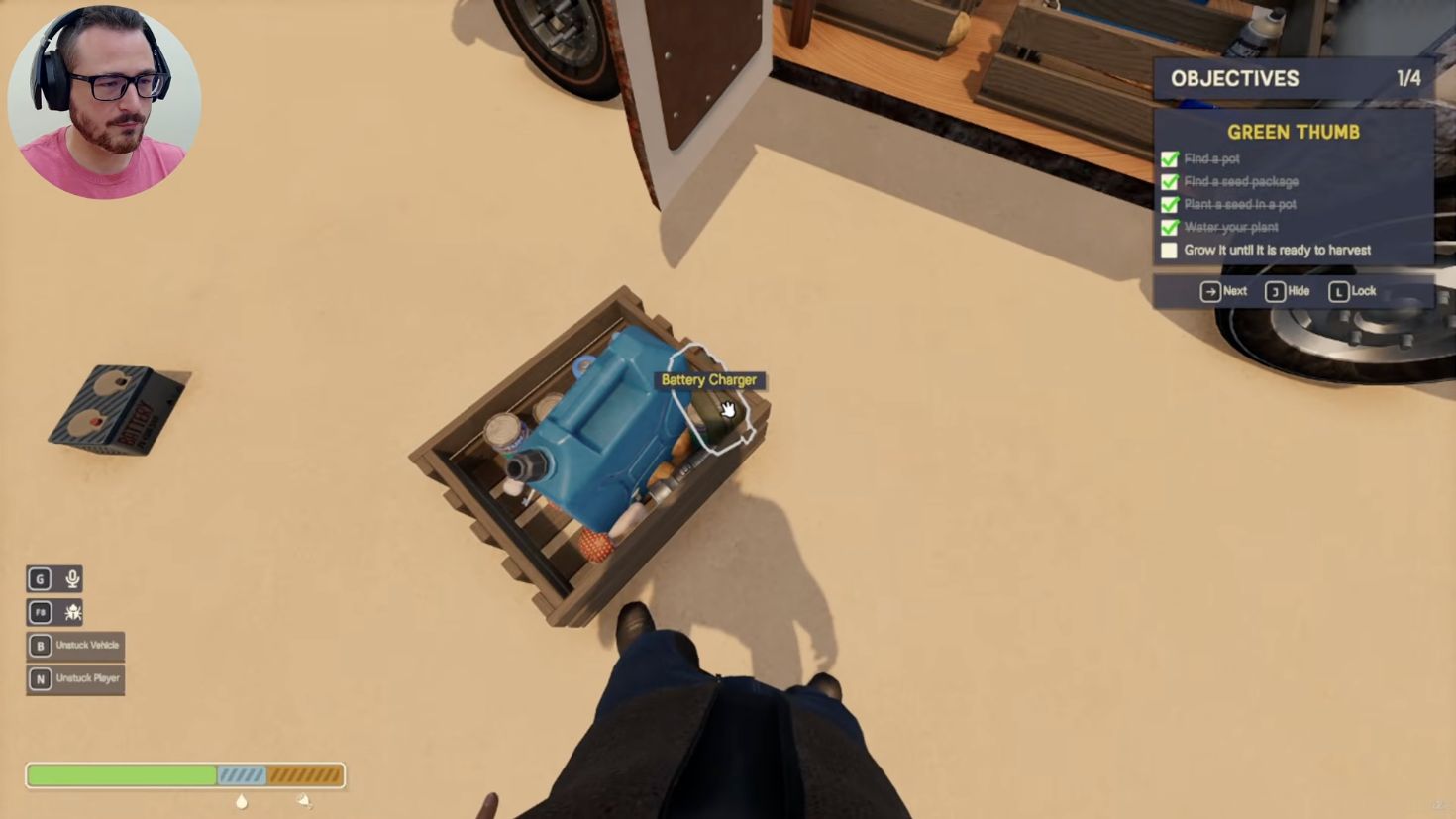 A Battery Charger beside a water jug in a supply crate